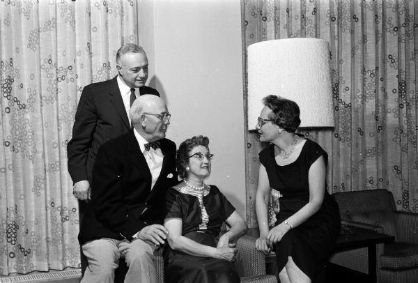 Two couples visit at the observance of Norway's Syttende Mai Independence Day, sponsored by the Ygdrasil Literary Society at the Wisconsin Center. Left to right are: Louis Kaplan, Henry and Clara Bakken, and Esther Kaplan.