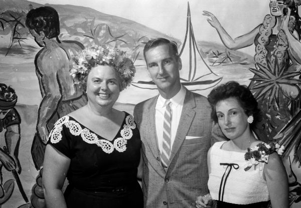 More than 300 members attend the East Side Women's Club annual dinner, themed "An Evening in Hawaii." Shown (left to right) are Miss Louise Maston, social editor of the Wisconsin State Journal and toastmistress of the annual spring banquet; Dr. Robert J. Samp, principal speaker; and Mrs. Samp.