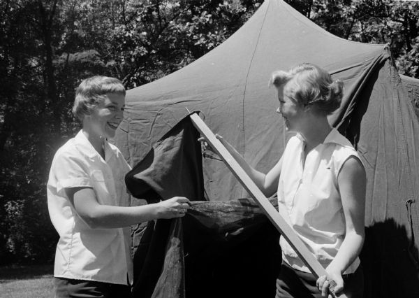 Winnie Neil Chapman and Betsy Paddock pitch a tent in preparation for the Girl Scout Round-Up in Colorado.