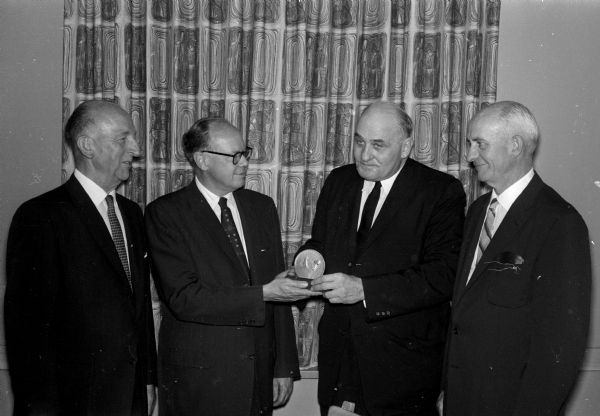 Valley Forge George Washington Honor Medal View of a ceremony awarding a Valley Forge George Washington honor medal from the Freedoms Foundation to the Wisconsin Power and Light Company for its efforts in the field of economic education. Representing the foundation is Roland J. Steinle, Milwaukee, second from the right. Accepting the award are, left to right: C.C. Herrmann, John Canfield, and J.D. Howard.