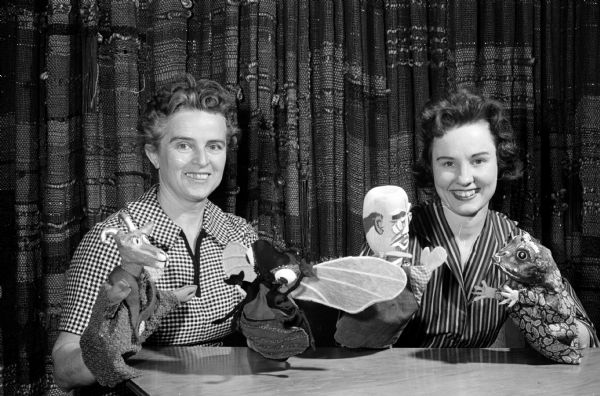 Benefit Puppet Play Portrait of Katarina Lettau, left, who helped make the puppets in the foreground, and Donna Zegarowicz, director of the upcoming puppet play, "The Ugly Toad" written by Francis Hole. Proceeds of the show, sponsored by the Madison branch of the Women's International League for Peace and Freedom and the Unitarian Meeting House, will go the Meeting House nursery fund and the League's Jane Addam's Centennial fund.