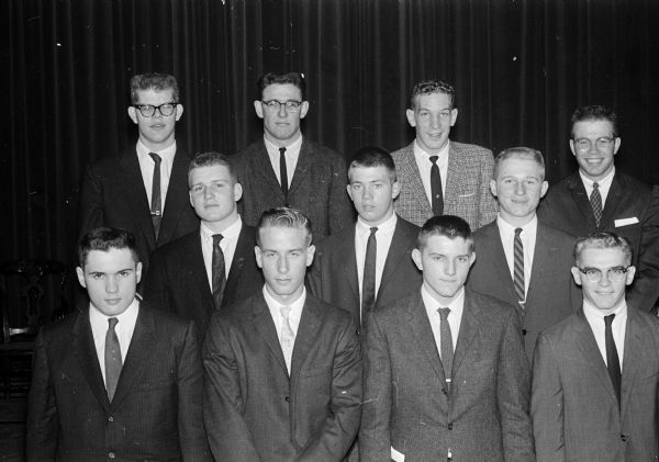 Group portrait of the Shriner Madison All-City high school football team. First row, left to right:  Steve Nelson, West; Ray Winburn, East; Doug Hyalop, East; James Wolier, East. Second row: Bill Daliman, West; Pete Berbink, Wisconsin; Bill Peckarts, East. Third row: Harry Kingbury, West; Ralph Farmer, West; Bill Maselter, East and Jim Armstrong, East.