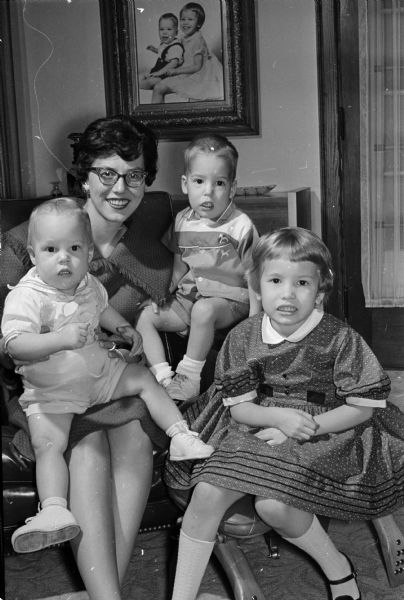 Delta Delta Delta Alumnae Chairman and Her Children Group portrait of Patricia Bruden with her children, including Christopher, left, Kent, center, and Lesli Jean. Bruden is chairman of the chapter's scholarship tea.