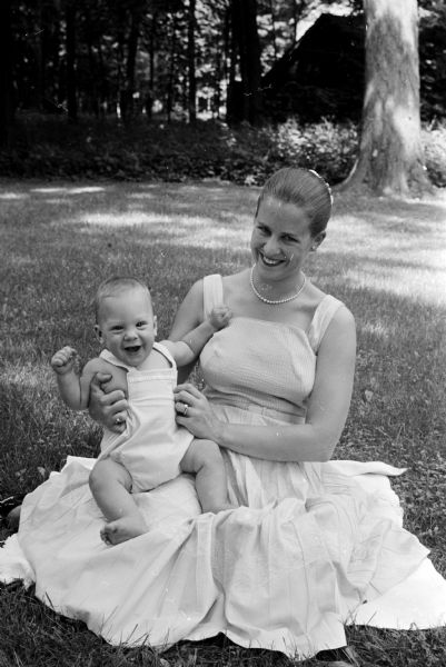 Mary Morris and Infant Son Sitting on a blanket on the lawn are Mary Roberta Morris, Santa Monica, California, and her seven month old son, Patrick Marling Morris. They are visiting her parents, Robert and Dorothy Marling.