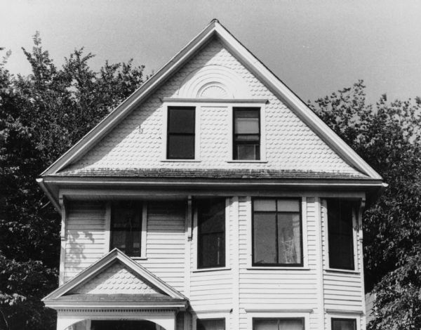 Decorative Shingles Scalloped design shingles decorate the roof, gable and pediment over the porch of this house at 305 North Livingston Street.