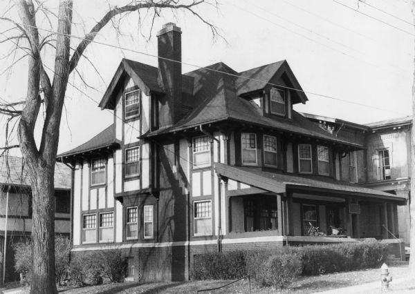 Exterior view of First Unitarian Society Parsonage, 504 North Carroll Street, designed by Claude & Starck and built  in 1910, in the Tudor Craftsman style. Details include half-timber construction, sash windows, and heavy brackets at the roof line.