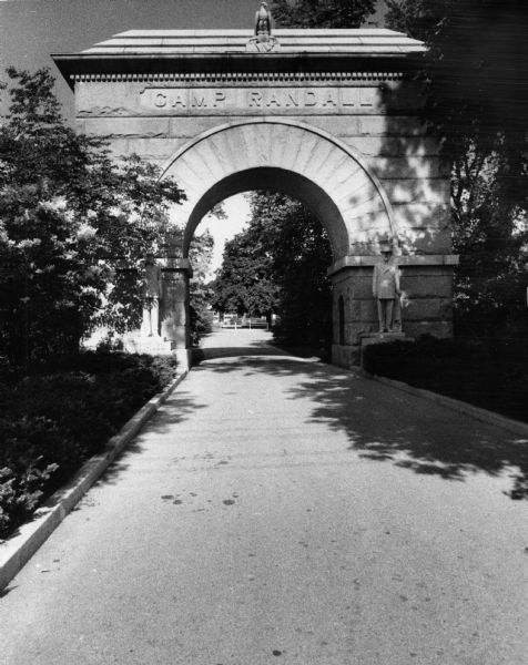 Camp Randall Arch, the entranceway to Camp Randall Stadium, which stands at the intersection of Dayton Street and Randall Avenue on the University of Wisconsin Madison campus. Statues of Civil War soldiers flank the arch as a reminder that the location was once a major military training center during the war.