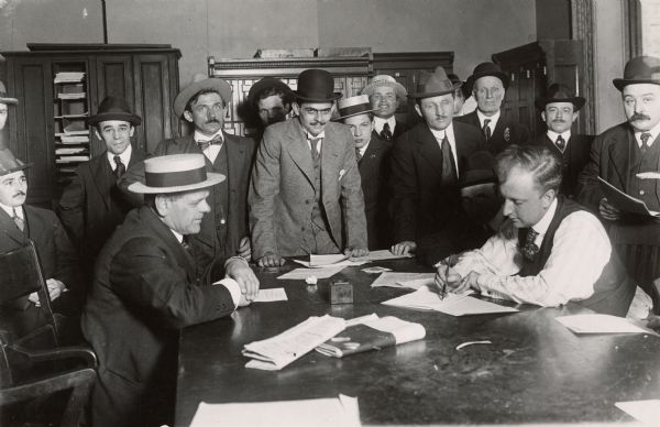 Unnaturalized Germans registering as enemy aliens at the New York Federal Building.  Registration was necessary for them to be able to travel within the various armory districts in New York City.