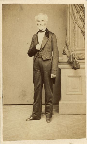 Full-length, carte-de-visite portrait of John H. Lathrop (1799-1866), first chancellor of the University of Wisconsin. Lathrop's tenure was marked by controversy with the faculty and legislature over the proper curriculum for the university and he resigned in 1858.