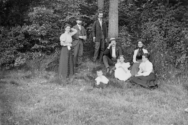 Group Portrait in Wooded Area A group portrait of three women and three men, a girl, and a young boy grouped in front of a wooded area.