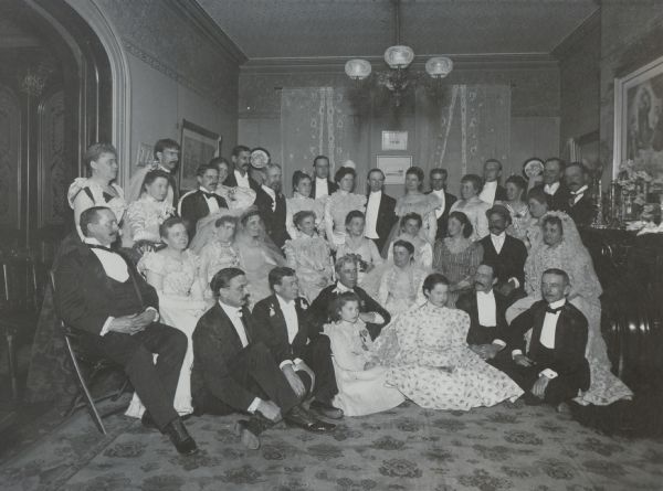 The fifteenth anniversary party of Mr. and Mrs. A.E. Proudfit, Madison, Wisconsin.  All guests wore their own wedding clothes.

Seated on floor, left to right: O.D. Brandenburg, Professor David B. Frankenburger, Elizabeth Proudfit, Mr. Proudfit, Mrs. Proudfit, Josephine Proudfit, A.B. Morris, and Frank Proudfit.

Seated in the second row, left to right: Harry Hobbins, Mrs. Hobbins, Mrs. David B. Frankenburger, Mrs. Frank Brown, Mrs. Levi M. Vilas, Mrs. O.D. Brandenburg, Mrs. Fred Brown, Mrs. Samuel H. marshall, Mr. Marshall, Mrs. A.B. Morris.

Standing, left to right: Miss Mary Louise Atwood, Mrs. Louis M. Hanks, Mr. Hanks, Fred M. Brown, Mrs. William S. Marshall, Professor Marshall, Frank Brown, Mrs. Stanley C. Hanks, Mr. Hanks, Mrs. Henry Vilas, Mr. Vilas, Mrs. Fred Spensley and Mr. Spensley, Mrs. Carl A. Johnson, Mr. Johnson, Mrs. Frank Edsall, Dr. Edsall, Frank Allis and Mrs. Frank Allis.