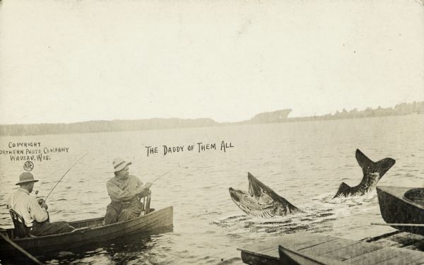 Two fishermen on a lake catch a giant fish. Both of the fishermen are wearing hats and one is smoking a pipe. A dock and the tip of a boat are in the foreground at right. Caption reads: "The Daddy of Them All."