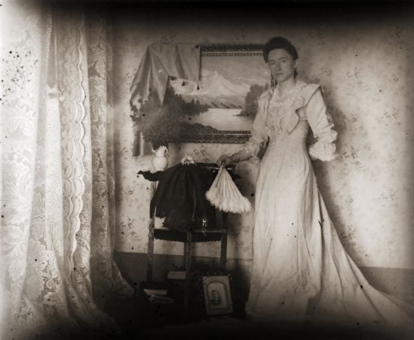 Ada Bass, the photographer's wife, posing in costume indoors.