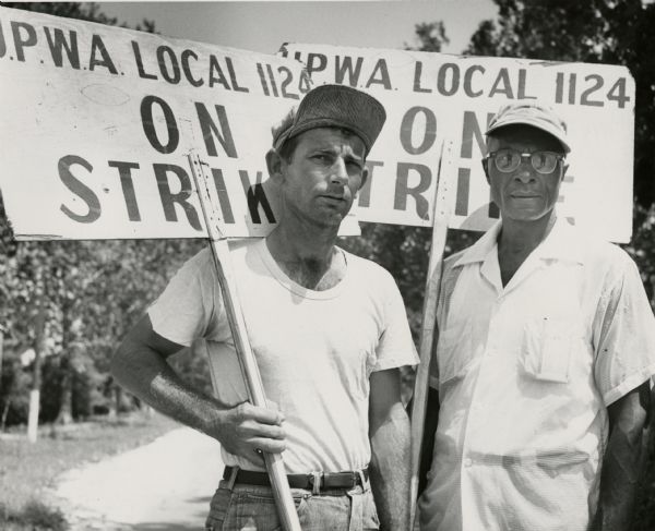 Two members of United Packinghouse Workers Local 1124 in New Orleans on strike against the Colonial Sugar Company.  They graphically symbolize the UPWA's dedication to organizing African Americans in the South. Although undated this image probably dates to the 1955 strike.