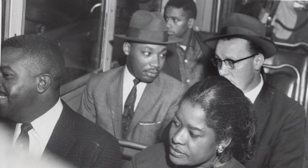 Rev. Martin Luther King, Jr. riding a bus with white Methodist minister Glenn Smiley during the Montgomery bus integration struggle.
The man seated in front of King is thought to be Ralph Abernathy.