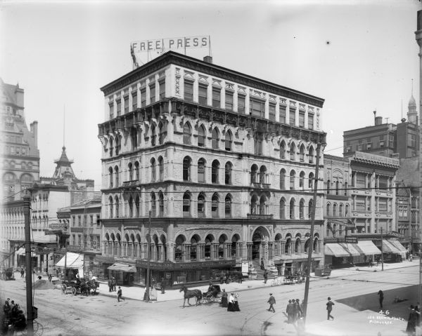 Elevated view across intersection towards the Milwaukee Free Press building at E. Wisconsin Avenue and N. Broadway (built as Northwestern Mutual's home office in 1870).