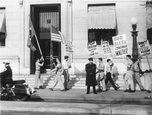Members of the American Nazi Party demonstrating in behalf of the House Un-American Activities Committee against liberal attempts to abolish the committee.  There is irony in this support for HUAC, which began in the 1930s as the Dies Committee whose purpose was to investigate Nazi subversions.  The photograph is undated, but it probably dates from the HUAC chairmanship of Francis Walter, 1955-1965.   This photograph is part of the records of the National Committee to Abolish HUAC (later the National Committee Against Repressive Legislation), which was formed in 1960.