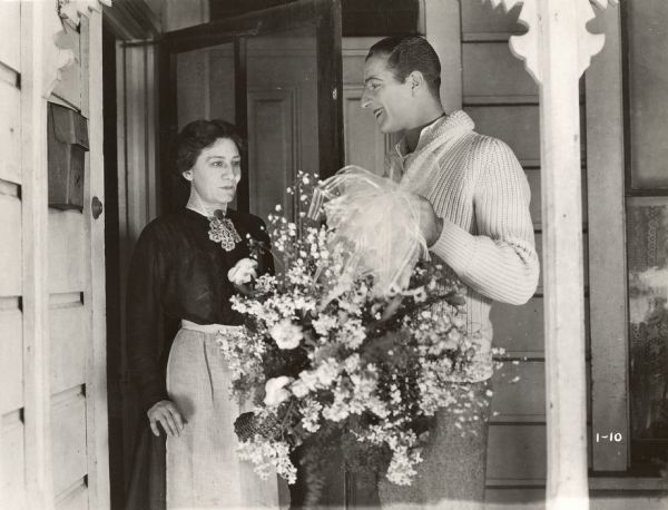 Publicity still from <i>The Blot</i>. Louis Calhern with flowers at the front door with Margaret McWade.  (Lois Weber Productions, 1921).