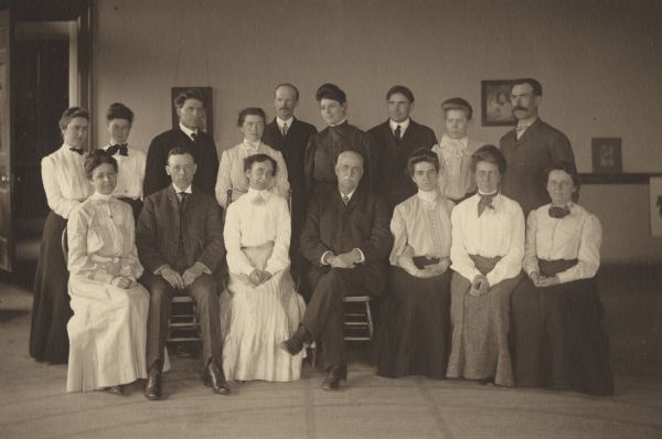 Group portrait of the Menomonie High School Faculty from 1905. Part of a 1905 yearbook created by classmate Albert Hansen, based on a class prophecy theme.