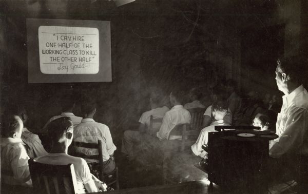 A movie being shown at Highlander Folk School.  Still frame reads, "I can hire one-half of the working class to kill the other half," a Jay Gould quote.  Gould was a famous American railroad developer and speculator.