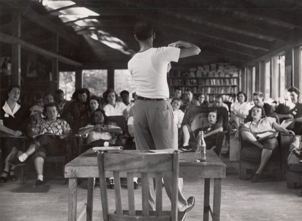A man giving a lecture to a group of students at Highlander Folk School. 
