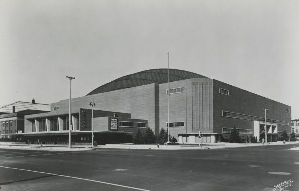 Milwaukee Arena on Kilbourn Avenue. There is a poster for Sonja Henie on the side of the building.