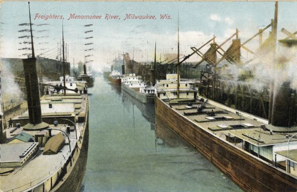 Elevated view of freighters lined up along the river. Caption reads: "Freighters, Menomonee River, Milwaukee, Wis."