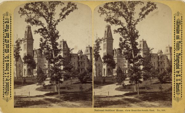 Stereograph. From the northeast (contrary to photographer's description.)  A large tree stands in the center of the image along the drive, with the home behind it.