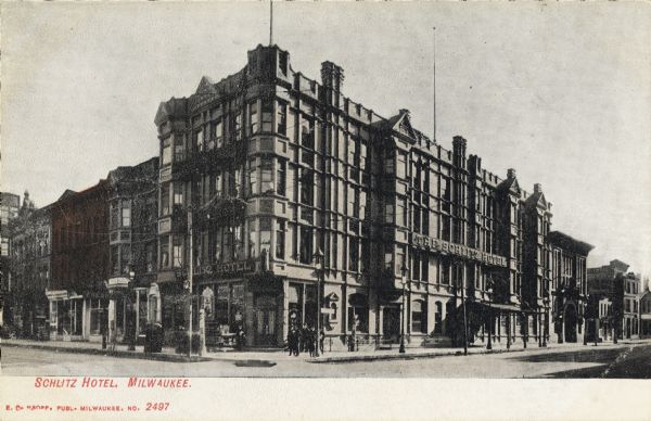 Schlitz Hotel View across intersection toward the hotel on the corner. Pedestrians are on the sidewalk near the building. Caption reads: "Schlitz Hotel, Milwaukee."
