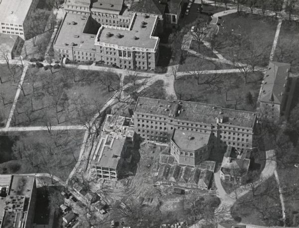 Aerial view of Birge and Bascom Halls (formerly Main Hall) on the University of Wisconsin-Madison campus.  Birge Hall (foreground) with addition under construction.  Bascom Hall is at the top of the image.