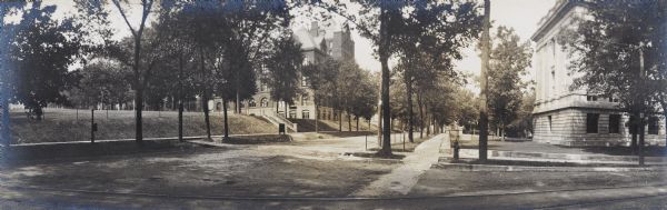 Panoramic view from the corner of Park and State Streets on the University of Wisconsin-Madison campus. Science Hall is on the left on the other side of Bascom Hill, and the State Historical Library (Wisconsin Historical Society) is on the right. 
