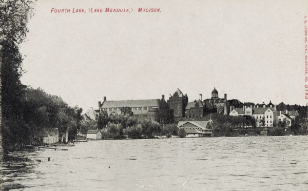 View from Lake Mendota of buildings on the University of Wisconsin-Madison campus. The boathouse, Armory (later the Red Gym or Old Red), and Science Hall can be seen along the shoreline, and Bascom Hall with dome is in the background. Text on postcard reads: "Fourth Lake, (Lake Mendota)."