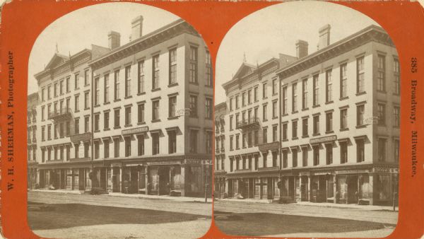 Stereograph of the Bradley & Metcalf building in the 300 block of East Water Street. On the corner first floor is Booth & Maynard's store which was located at 399 East Water Street.