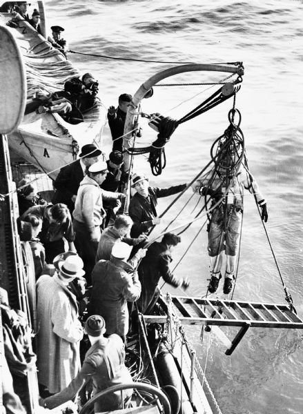 On April 10th, 1937, Max Nohl (shown in the dive suit) along with John Craig made a dive on the shipwreck <i>Norland</i> in order to perform another early test of the newly designed diving suit in conjunction with testing the helium-oxygen mixture that Dr. End and Max had been working on. The dive took place off the deck of the Coast Guard cutter <i>Antietam</i> about five miles out from Milwaukee's breakwater. The dive was broadcast by WTMJ over the NBC-Blue network and represented the first underwater broadcast every made. As a result of this dive and many other experiments, Max Nohl was able to set a new record deep dive in Lake Michigan on December 1, 1937.