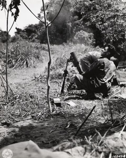 Sergeant Peter Merkel, a member of the 32nd Division from Milwaukee, firing a mortar somewhere in New Guinea.