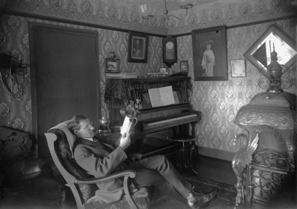 Otto G. Ansorge sits in his home on Lake Avenue and reads. Ansorge was a jeweler and band director in Winneconne.