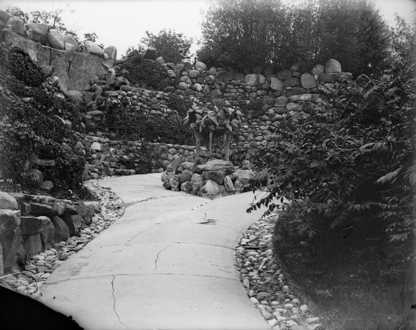 Extensive stonework lines the garden path at the Ceylon Building, which is originally from the Columbian Exposition in Chicago. The building was purchased by J.J. Mitchell, moved to Lake Geneva, and converted to a private residence.