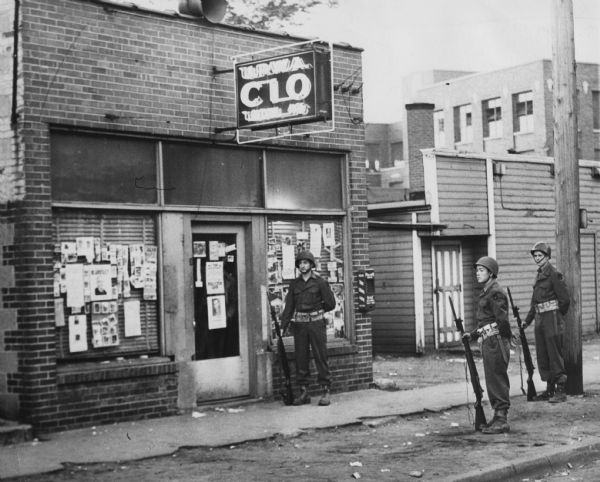 National Guardsmen stand guard outside the headquarters of Local 46 of the United Packinghouse Workers of America after the shooting of a striker at the Rath Packing Company set off a wave of violence.