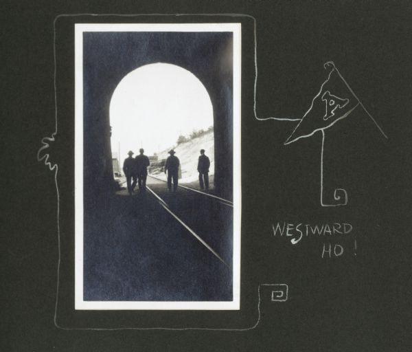 View from inside railroad tunnel of four men walking near the entrance on railroad tracks. A hand-drawn border features a pennant with the letter "A" on it, and a caption reads, "Westward ho!"