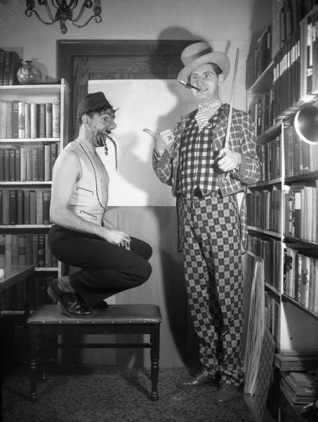 Bloch dressed as the "Geekmaster" and Gauer as the "Geek." Gauer is "geeking" a wooden snake in the photograph. It was to be used to illustrate an unpublished article on Geeks, that Gauer was writing.