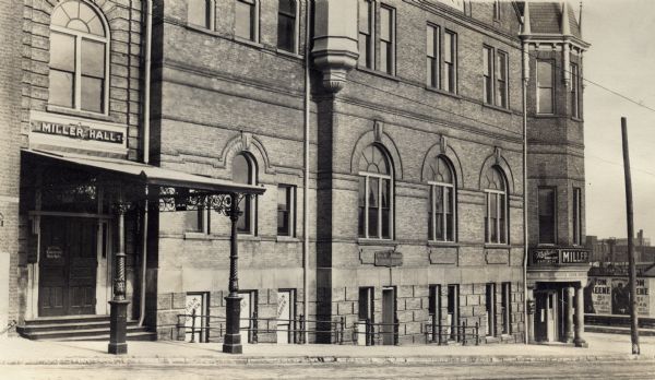 Miller Hall Miller Hall, a saloon recreation center in Milwaukee. In windows below the main entrance to the right are three signs advertising Palm Gardens. Another sign on the corner of the building in the far right advertises for Miller High Life.