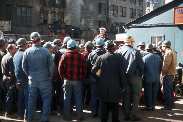 Construction workers gather to meet near the office for the Sand Chapter of Mechanical Contractors before beginning work during the construction of the World Trade Center.
