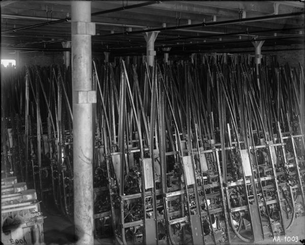 Factory storage room, probably at the McCormick Works, filled with farm implement components.
