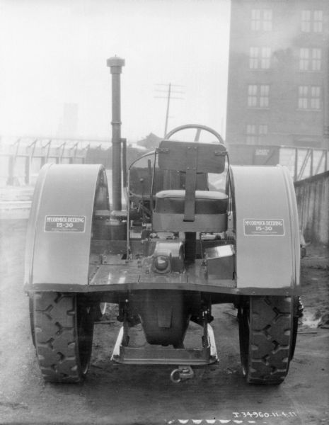 McCormick-Deering 15-30 Tractor Rear view of a 15-30 tractor. In the background are industrial buildings.