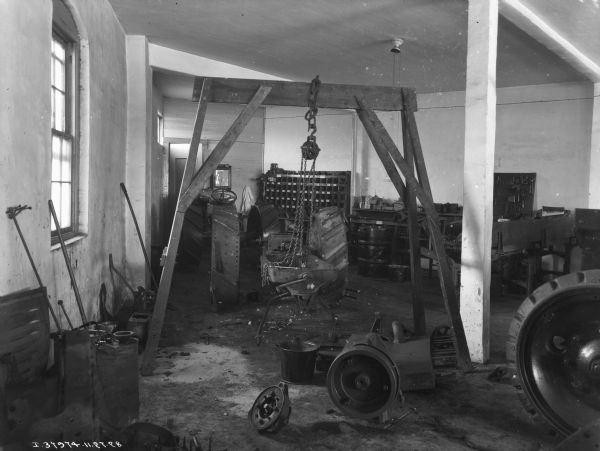 Interior view of repair shop at implement store. A tractor is in the background.