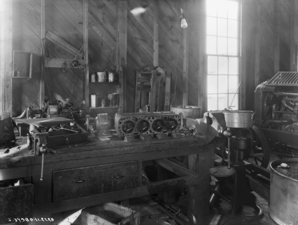 Interior view of repair shop at implement store. There is a tractor on the far right.
