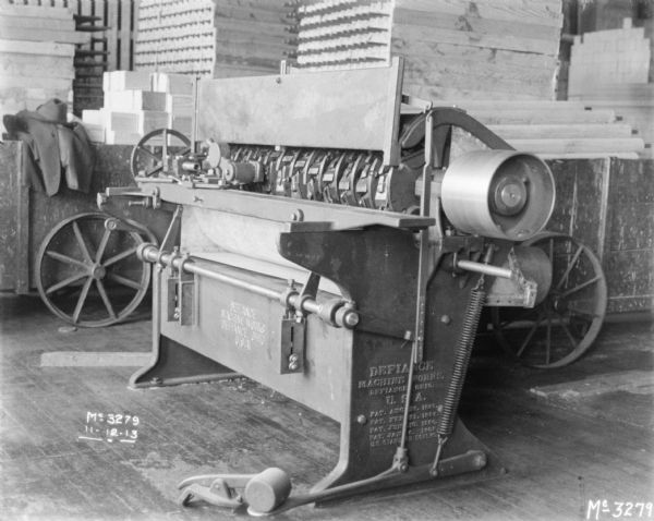 Manufacturing Machine Manufacturing machine in a factory. The side of the machine reads: "Defiance, Machine Works, Defiance, Ohio, USA."