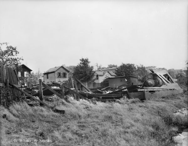 Collapsed Building View of a collapsed building. Houses are in the background.