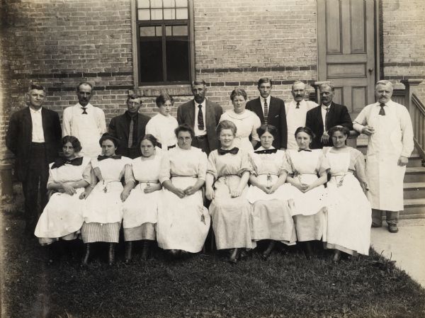 Group portrait outdoors of the administrative and nursing staff of the Winnebago County Asylum. Pictured in the center back row is E.E. Manuel, the Superintendent. To the right of E.E. Manuel is his wife, Olphene (Stromme) Manuel, the Matron of the Asylum. And to the left of him is his daughter, Bessie L. Manuel, who served as the bookkeeper at the Winnebago County Asylum and Poor Farm.