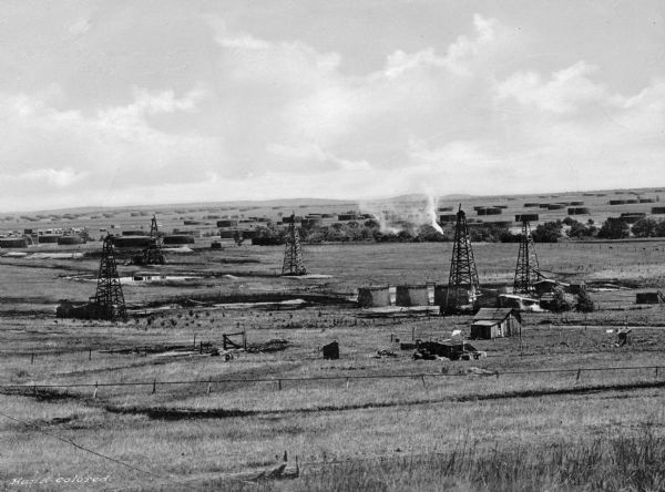 A view of rows of oil derricks and steel tanks at Glenn Pool Oil Field where oil was first discovered on November 22, 1905 by Robert Galbreath and Frank Chesley. The Glenn Pool has produced 340 million barrels of oil since that day.
